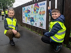 Local pupils with some of the artwork now displayed at Mills Hill station