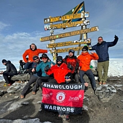 Stephen Shea, Simon Regan, James Keeling, Ryan Mathers, Patrick Altimus, John Finnerty, Lee Ashworth, and Liam Jones at the summit of Kilimanjaro