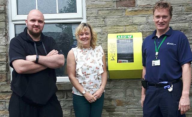 Julie Durrant & Mark Oldham from Littleborough Boxing and Fitness Club with Rod Cape of North West Ambulance Service with the new CPAD (Community Public Access Defibrillator)