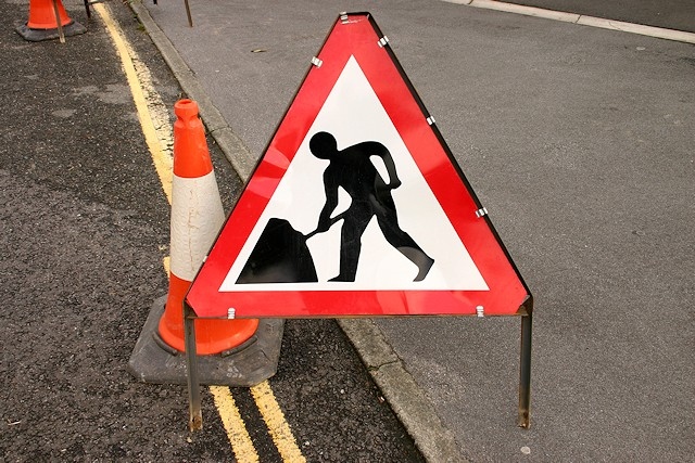 Roadworks sign and red cone