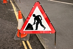 Roadworks sign and red cone