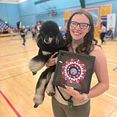 Rebecca with Phoebe the poodle after accepting their award 