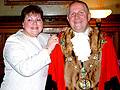 Cllr. Angela Coric places the chain on the new Mayor
