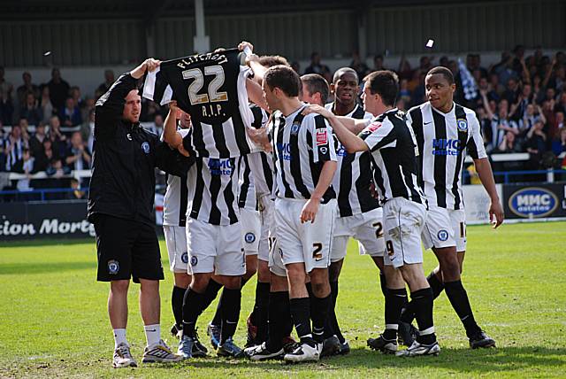 The Dale players celebrate their goal by holding up a shirt in tribute to David Flitcroft's father