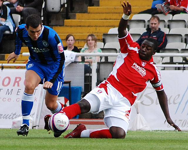 Rotherham captain Pablo Mills puts in a tackle on Adam Rundle.