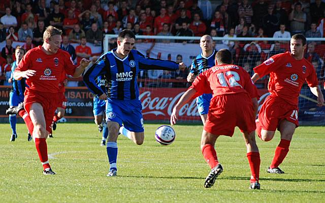 Dale sub Chris Dagnall is crowded out by Accrington defenders.