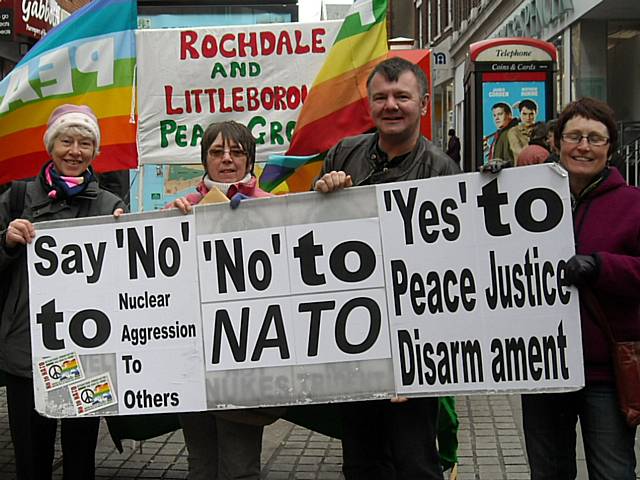 Pat Sanchez, Pauline Devine, Andrew Wastling and Patricia Gilligan holding the Peace Group’s giant ‘No to NATO’ placard.