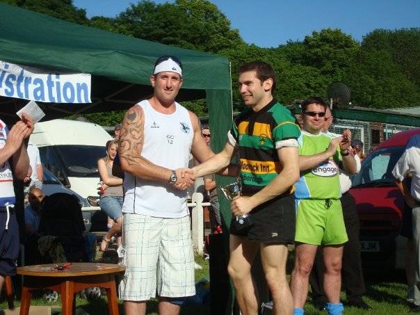 Rochdale based Irish Rugby League International Ged Corcoran presents the Littleborough Lightening captain with the winner's trophy.