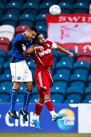 Rochdale 3 - 3 Swindon Town<br />Marcus Holness wins the aerial battle with Thomas Dossevi