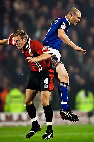 Rochdale v FC United of Manchester - Gary Jones jumps with Nicky Platt