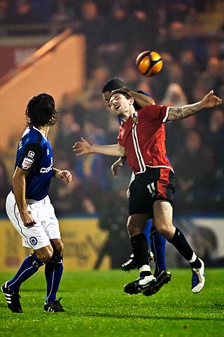 Rochdale v FC United of Manchester - Marcus Holness beats Ben Deegan in the air