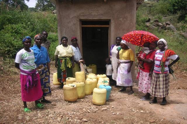 Some of the women queueing at the kiosk to collect the clean rain water from the tap. The yellow containers hold 20 litres of water.