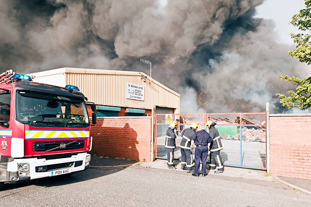 Fire fighters attempt to unlock the factory gate