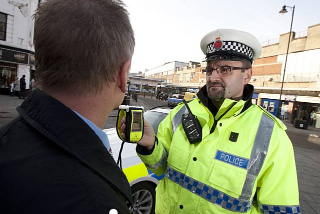 Police officer carrying out breath test