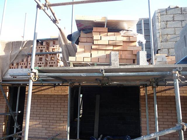 Stacked bricks on scaffolding