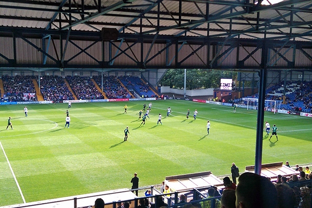 The game is taking place at Gigg Lane in Bury