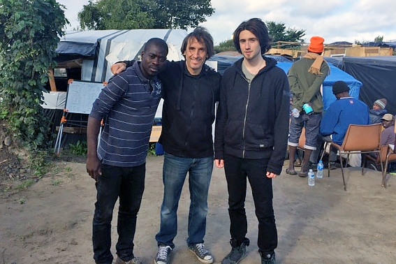 John Farrington (centre) at the refugee camp in Calais