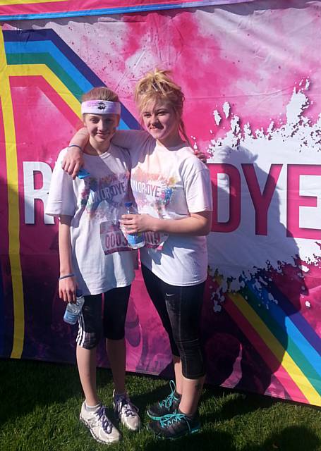 Runners, from left, Alex Lord and Courtney Witter take part in the Run of Dye charity fun run