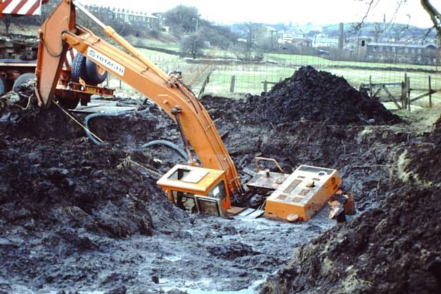 A sunken digger on theHeritage Green field during previous building work