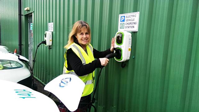 Councillor Jacqui Beswick plugs in one of the new electric vehicles
