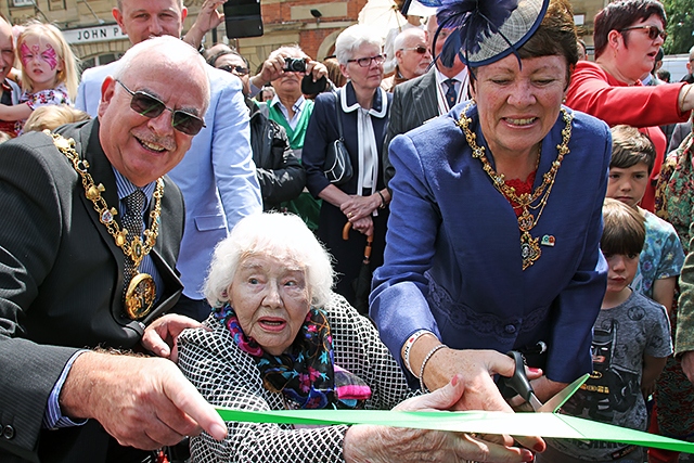101-year-old Alice Nicholson with Mayor Ray Dutton and Mayoress Elaine Dutton cut the ribbon at the re-opening celebration