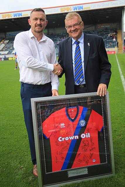 Retail Manager Stuart Ashworth presented with a leaving gift from Chairman Chris Dunphy on the pitch at half time on Saturday for his final home game at Rochdale AFC