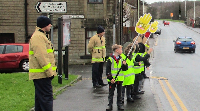 Children from St John with St Michael remind motorists of the dangers of speeding and parking dangerously near a school