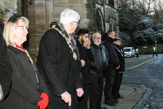 Mourners, including Mayor Ian Duckworth and Mayoress Christine Duckworth, await the funeral cortege outside Rochdale Town Hall