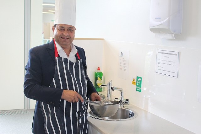 Councillor Ahmed gets ready to cook up a special thank you to council staff