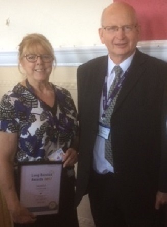 Chris Verity, Health Visitor, receiving her Long Service Award certificate from John Schofield, Chairman
