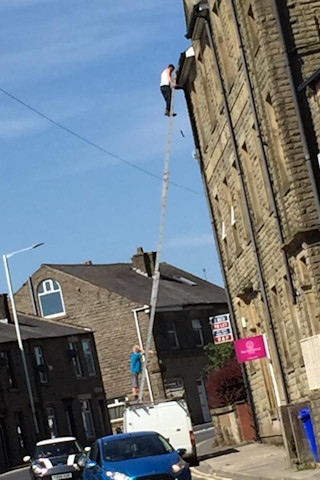 The man was snapped on the ladder balanced on the transit van in Whitworth