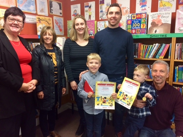 Joseph Lupton is congratulated on his Summer Reading Challenge success by Councillor Janet Emsley (l), cabinet member for libraries, and family members