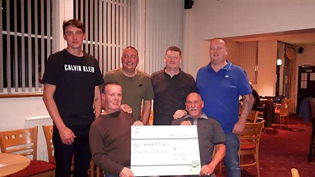 Members of Heywood Bowling Club presented Springhill Hospice with a cheque