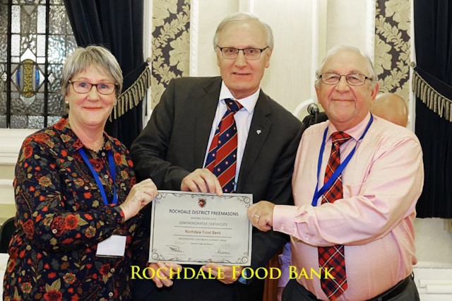 Iain and Margaret Wight receive their scroll from the Rochdale District Freemasons