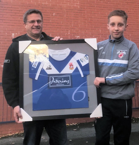 Chris Taylor from Trendmost Interiors receiving a framed jersey from Mayfield u11 player Jake Ramsden 