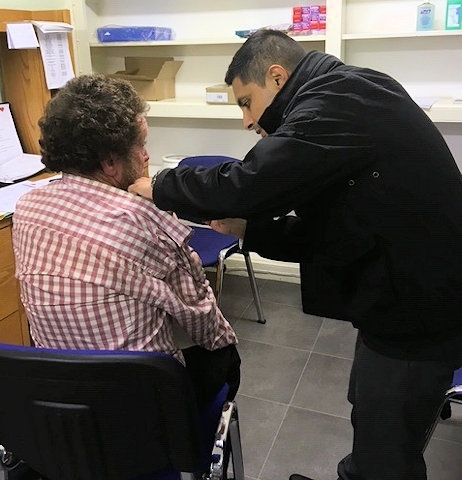 HART volunteer delivers flu vaccination in the soup kitchen clinic