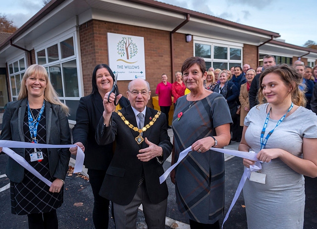 Councillor Billy Sheerin, deputy mayor of Rochdale, cuts the ribbon to declare the Willows Dementia Hub open
