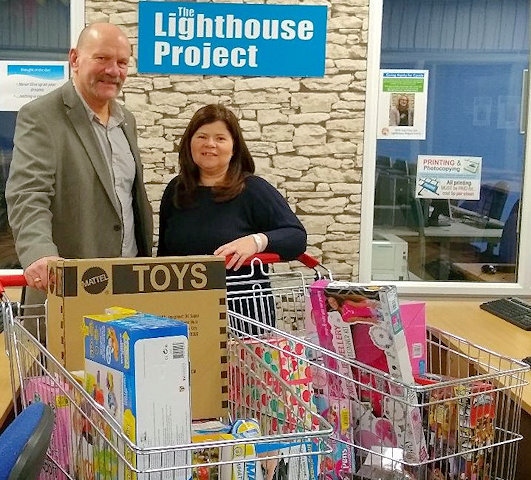 Keith Trinnaman, Treasurer of Middleton Rotary Club with Cath Stott, Middleton Foodbank with the trolleys full of presents that will be passed on to the children in the next few days