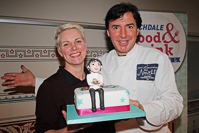 Rochdale Food and Drink Festival<br /> Local artisan cake-maker, Natasha Brown presents Jean-Christophe Novelli with a cake, complete with a sugar-paste portrait of him