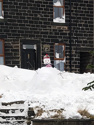 The smiley snowman built by two-year-old Stanley Booth and his Daddy
