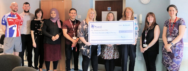 RBH charity champions present Rochdale and District Mind Chief Executive Tricia Hornby with the proceeds of their phone sales