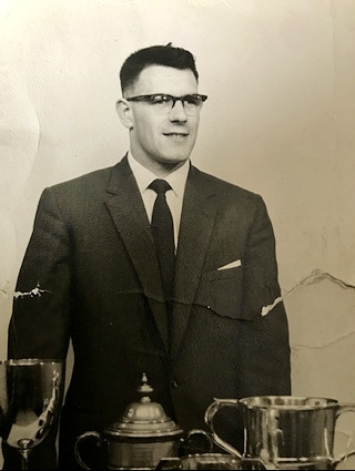 Geoff, aged 21, with his trophies for running