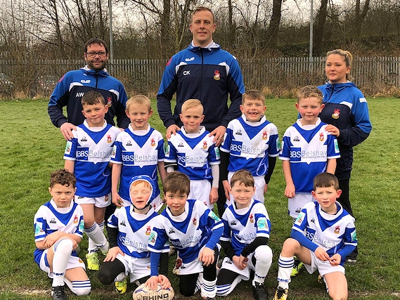 Mayfield Mustangs U7s showing off their new kit before a recent game, with Coach Craig Kopczak of the Salford Red Devils.