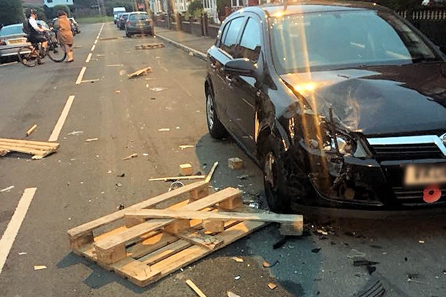 The pallets flew from the van, damaging several cars