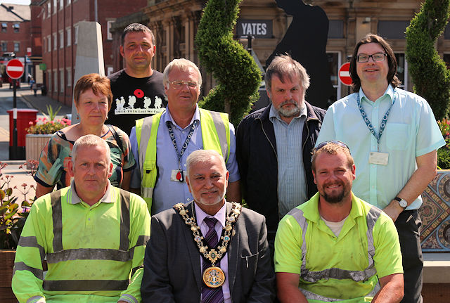 Mayor Mohammed Zaman, Rochdale in Bloom volunteers, workers from Marshalls and council workers at the opening of the pop-up World War One Garden