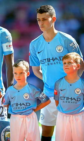 Dylan McLachlan (left) at Wembley Stadium as a player escort for Phil Foden ahead of Manchester City winning the Community Shield for 2018