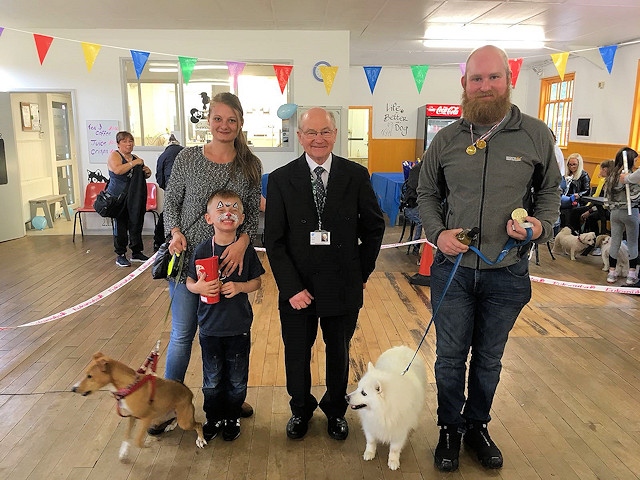 Councillor Billy Sheerin awards Best in Show to Prince and owner David Cockcroft and runner-up to Maggie with Tommy and Sarah Parkinson