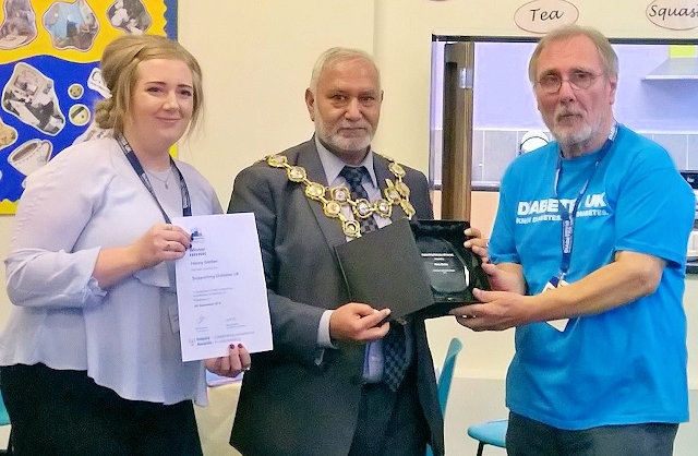 Emma Parke from Diabetes UK, the Mayor of Rochdale Mohammed Zaman and Henry Gerber with his Inspire Award from Diabetes UK