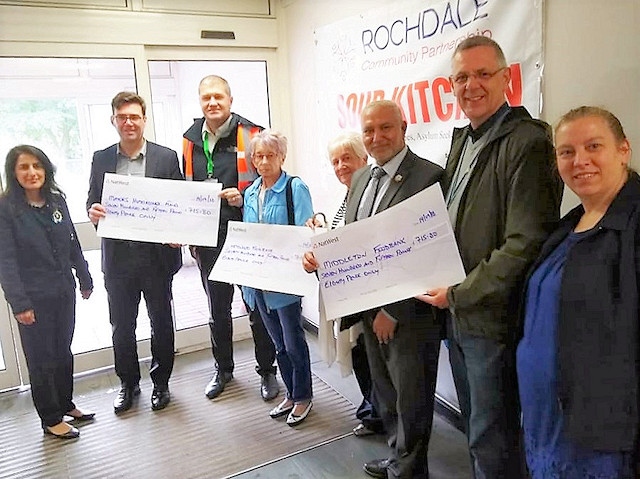 Former councillor Chris Furlong (third from left) presented three cheques to charity raised from his ‘Three Marathons-Three Months-Three Countries’ challenge earlier this year