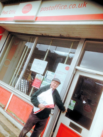 Councillor Billy Sheerin posts a parcel at the newly opened Post Office